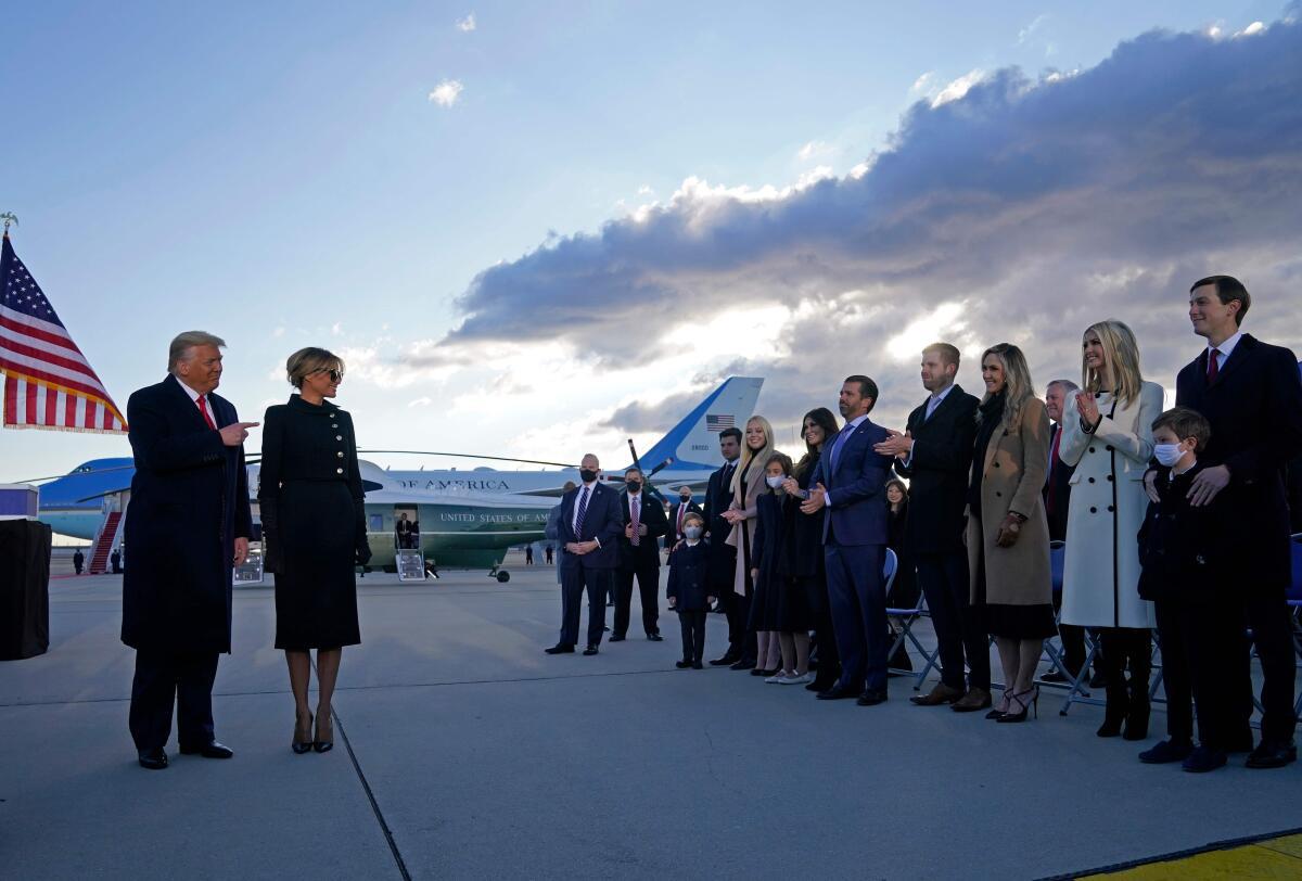 U.S. President Donald Trump and First Lady Melania are greeted by Ivanka Trump (second right), husband Jared Kushner (right), their children, Eric (centre right) and Donald Jr. (centre left), Tiffany Trump and other Trump family members on the tarmac at Joint Base Andrews in Maryland on January 20, 2021.