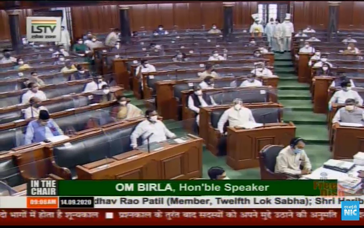 Lok Sabha members attend proceedings maintaining social distance.
