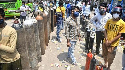 Big rush: Kin of patients waiting to refill empty oxygen cylinders in New Delhi on Tuesday.