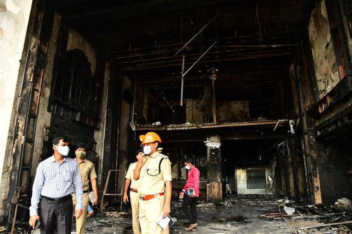Fire and Police Departments personnel inspecting the Hotel Swarna Palace-cum-COVID care centre in Vijayawada.