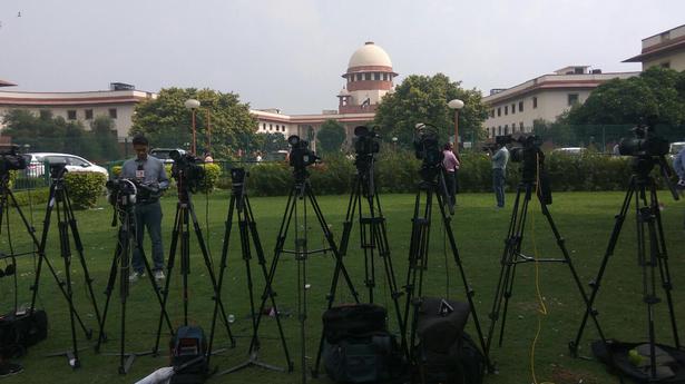 Cameras set! Reporters wait for the Triple Talaq judgement outside supreme Court in New Delhi on Tuesday.