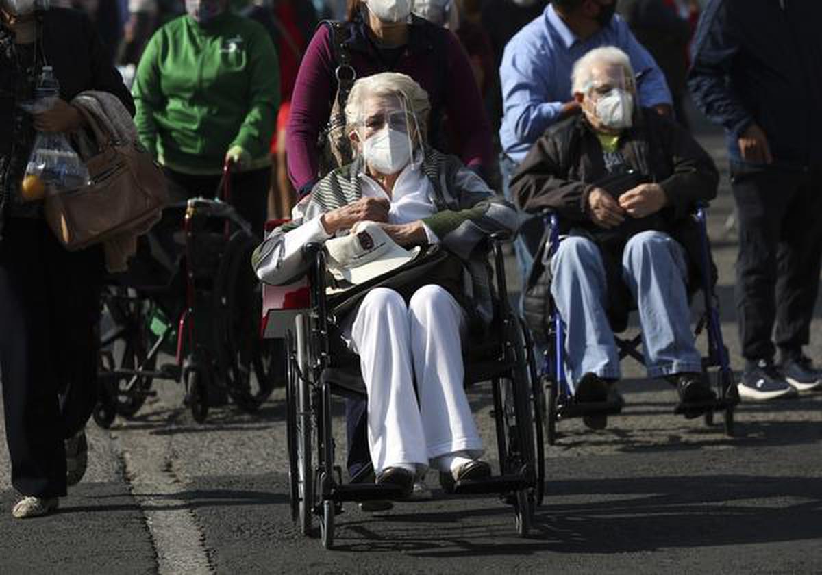 Elderly people are wheeled away after getting their shot of the COVID-19 Pfizer vaccine in Mexico City, on Monday, March 8, 2021.