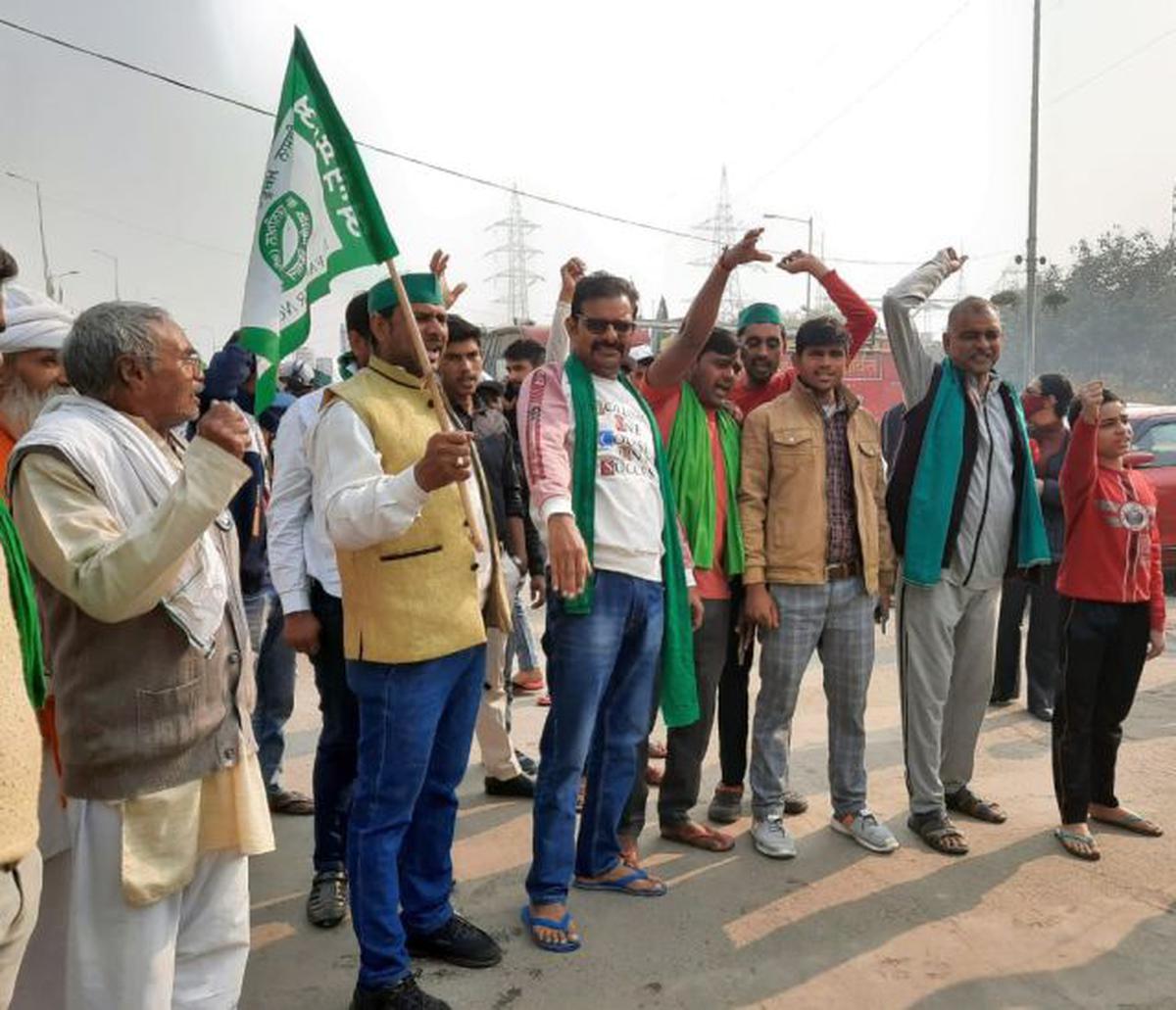 Farmers celebrating the Centre's decision to taking back the farm laws, at the Ghazipur border on Friday, November 19, 2021.