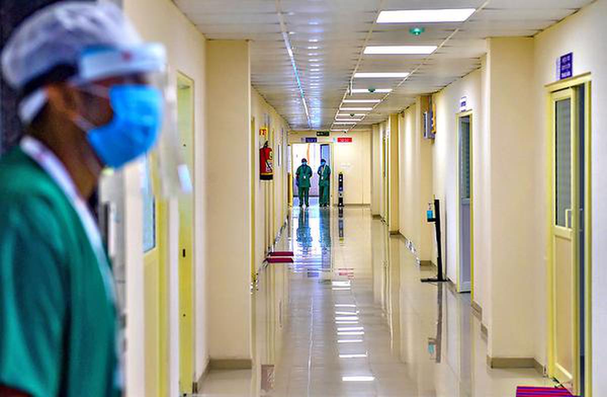 A file photo of health workers walking along the corridor of an ICU ward for COVID-19 patients at a hospital in Bengaluru.