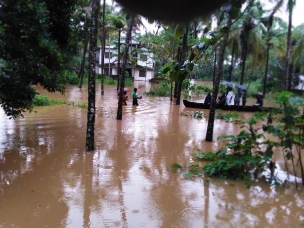 Residents being shifted from flooded areas at Pamburuthi, a small river island in Kannur on Friday