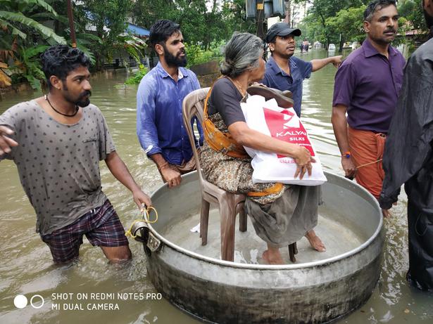 An elderly woman being carried out of her home in Punkunnam, Thrissur