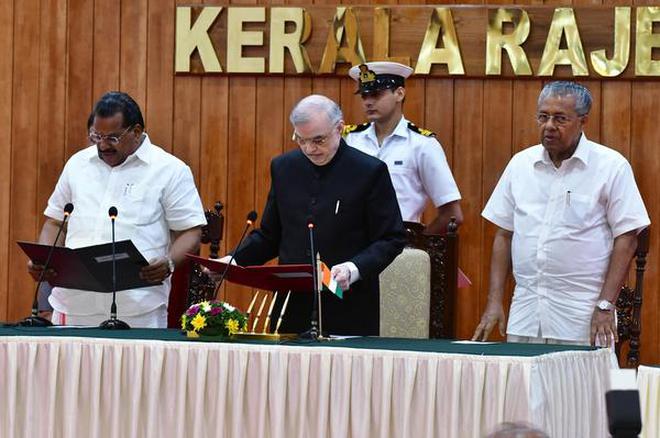 Kerala Governor P Sathasivam administering the oath of office and secrecy to EP Jayarajan as a Minister of Kerala government at rajbhavan in Thiruvananthapuram on Tuesday as Chief Minister Pinarayi Vijayan look on