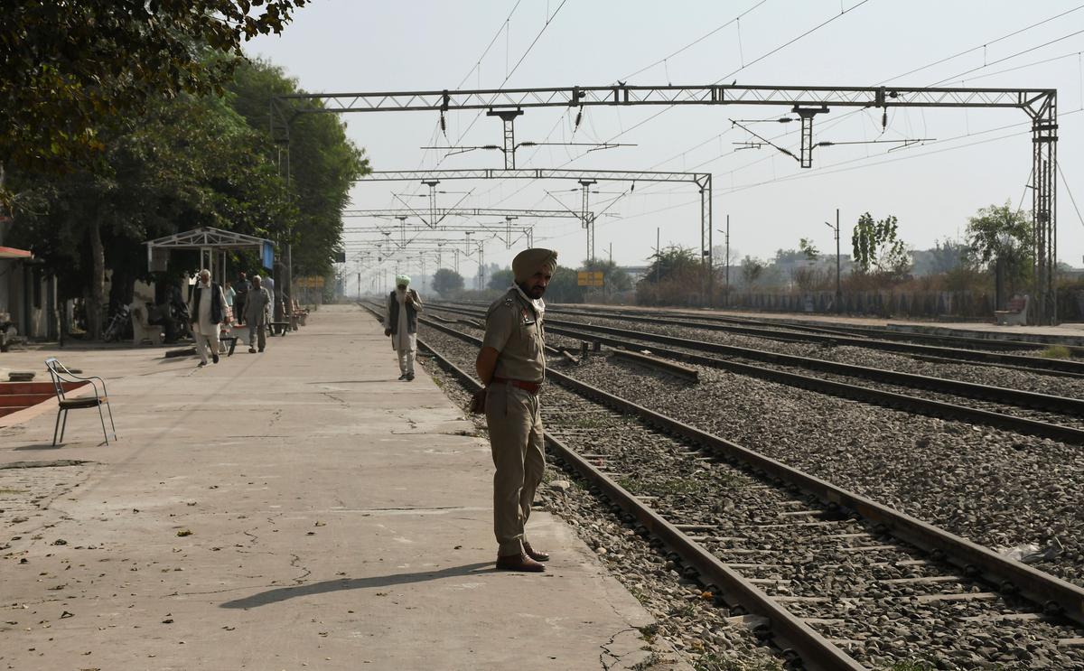 A policeman keeps vigil to keep farmers off the tracks at Shambhu railway station in Punjab’s Patiala district on November 11, 2020.