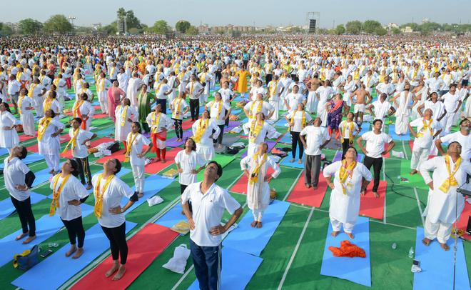 Enthusiasts perform yoga during an event to set the Guinness World Record for the largest yoga lesson during the International Day of Yoga at Kota in Rajasthan on June 21, 2018.