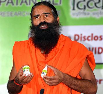 Yoga guru Ramdev addresses the media during the launch of 'Coronil' and 'Swasari' ayurvedic medicines, claimed by Patanjali Ayurved to cure coronavirus disease, in Haridwar on June 23, 2020.
