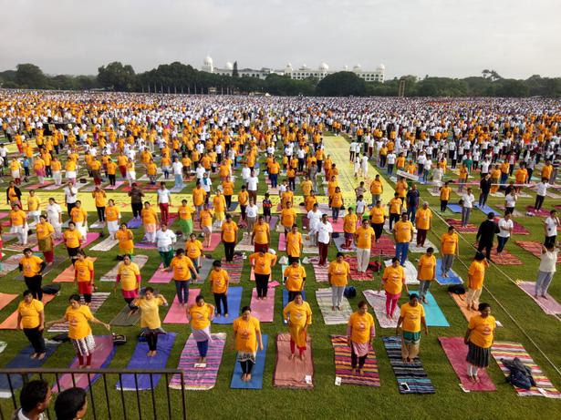 Participants perform yoga at Mysuru Race Club on the occasion of International Yoga Day.