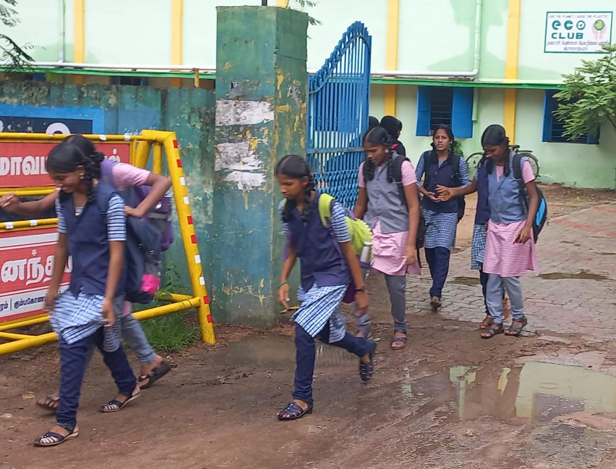 Girl students of Municipal Girls Higher Secondary school who came to school on Monday, returning home after the district administration declared holiday in view of rains
