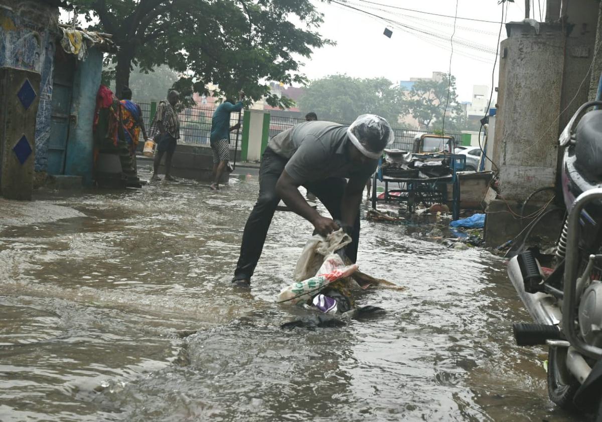 Corporation worker clearing garbage in flood affected areas at Egmore on Monday