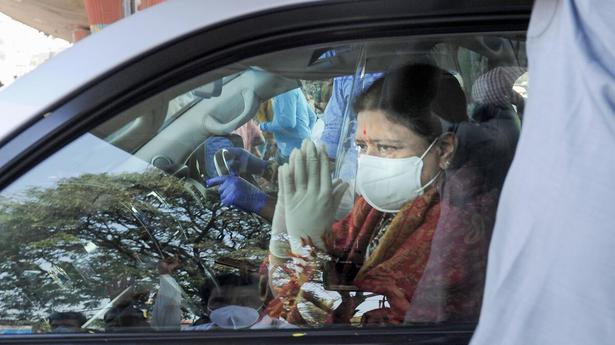 Expelled AIADMK leader V.K. Sasikala greets her supporters as she leaves Victoria Hospital in Bengaluru on January 31, 2021. 
