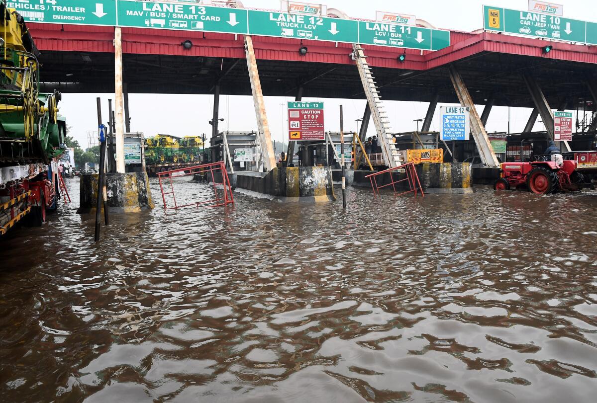 Vehicles struggle through the stagnated rain water at Chozhavaram toll plaza on the Chennai-Kolkata Highway on November 9 2021.