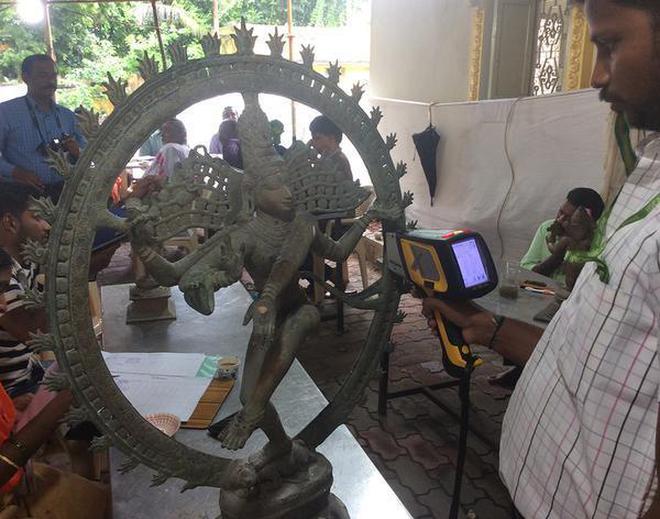 A Nataraja idol being subjected to analysis at the Tiruvarur temple.