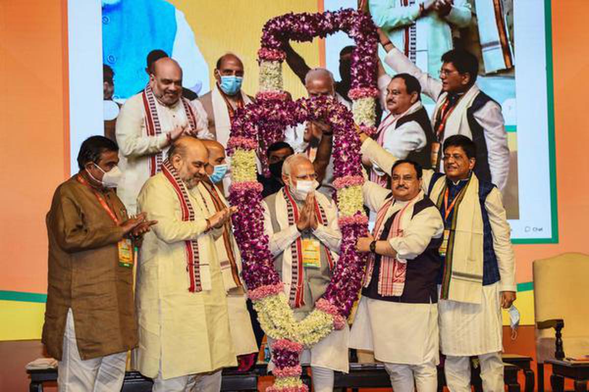 Prime Minister Narendra Modi being felicitated with a garland by BJP leaders during party's national executive meeting at NDMC Convention Centre in New Delhi.