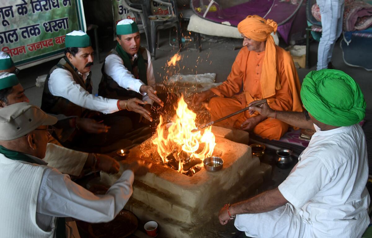 Farmers performing havan while celebrating the repealing of three farm laws at Ghazipur border protest site in New Delhi on Friday.