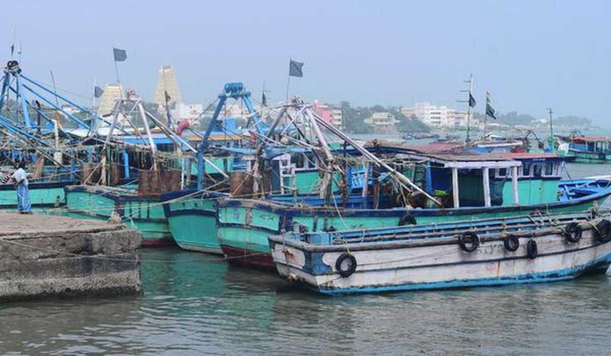 Fishermen hoist black flags on their boats as a mark of protest following the death of four fishermen in Palk Strait.
