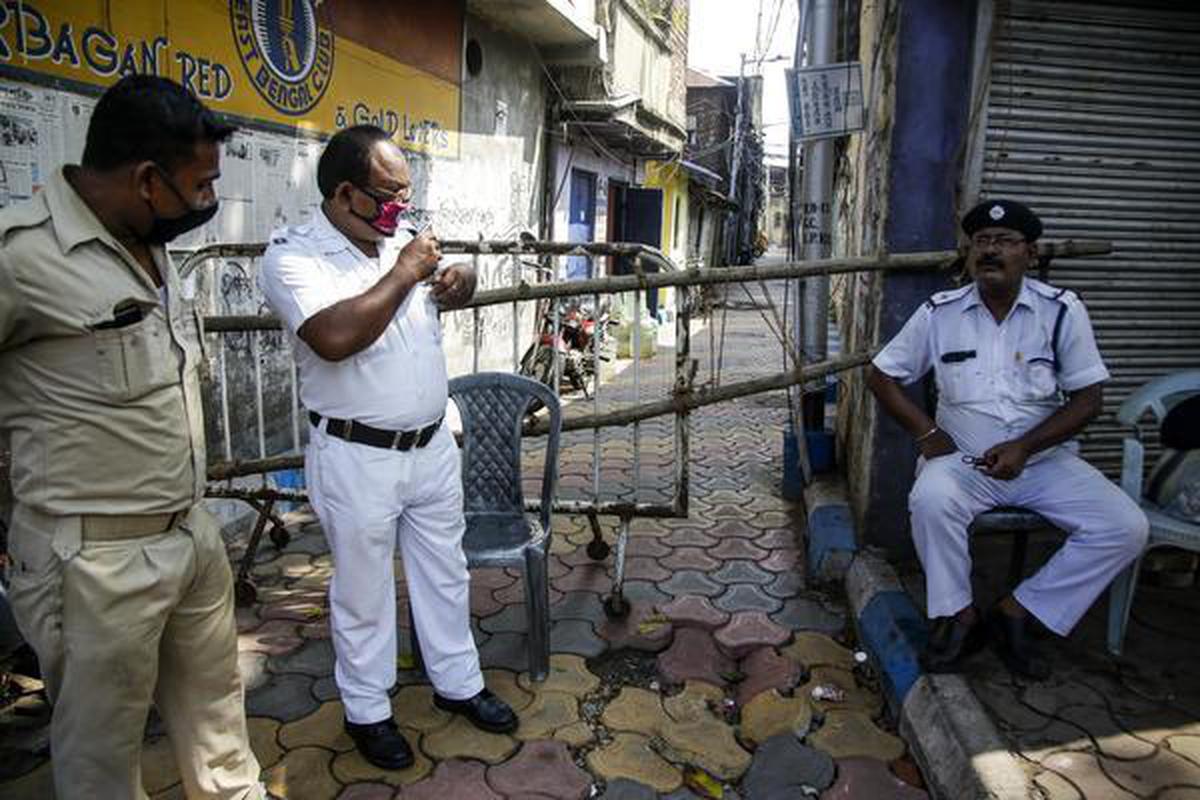 Policemen keep vigil outside a containment zone in Kolkata on July 14, 2020.