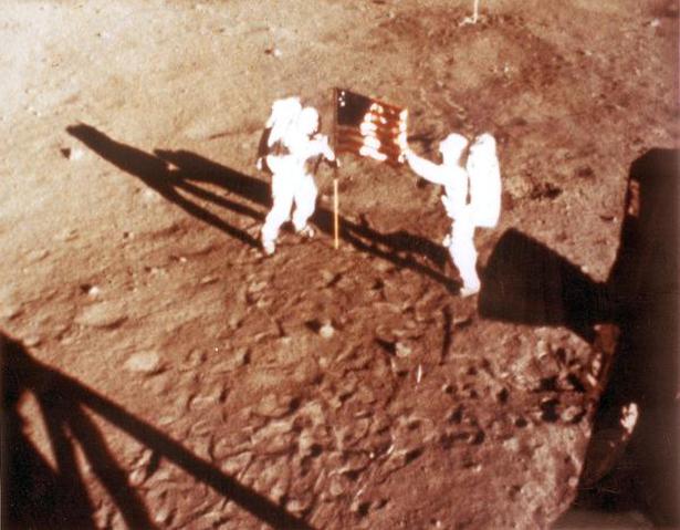 (FILES) In this NASA handout file photo taken on July 20, 1969 US astronauts Neil Armstrong and "Buzz" Aldrin deploy the US flag on the lunar surface during the Apollo 11 lunar landing mission.