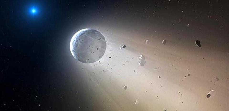 This artist's rendering provided by the Harvard-Smithsonian Center for Astrophysics shows an asteroid slowly disintegrating