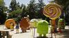 File photo of people pose by Android lawn statues at Google’s headquarters in Mountain View, California.