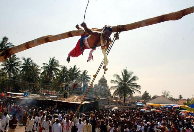 A man performs Sidi in Hassan, a ritual involving inserting hooks on the back and suspending from a pole.