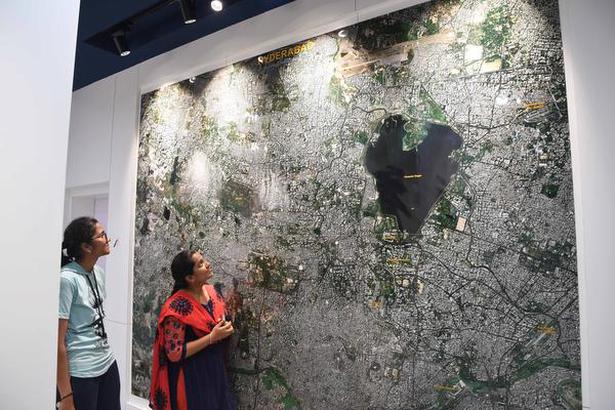 Visitors looking at a satellite map