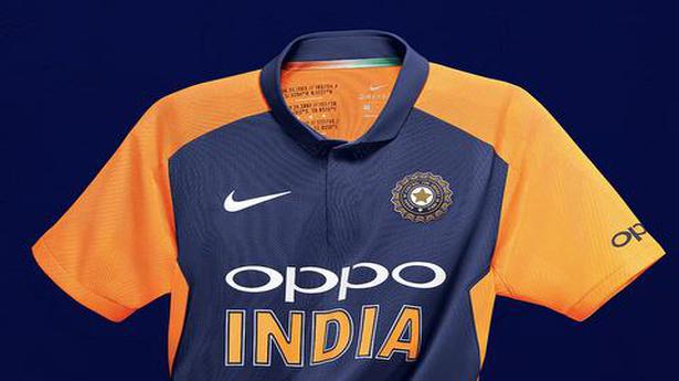indian cricket team in orange jersey