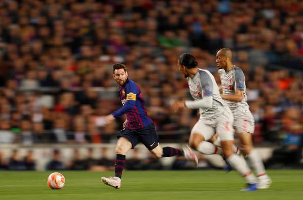 Barcelona's Lionel Messi in action with Liverpool's Fabinho and Virgil van Dijk